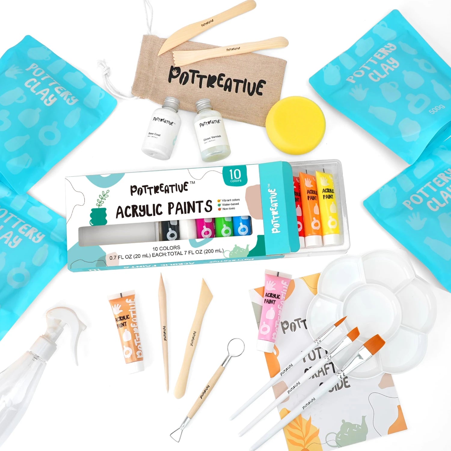 Top-down view of all contents in the all-in-one air dry clay pottery kit, showing clay, paints, brushes, sculpting tools, and varnish.