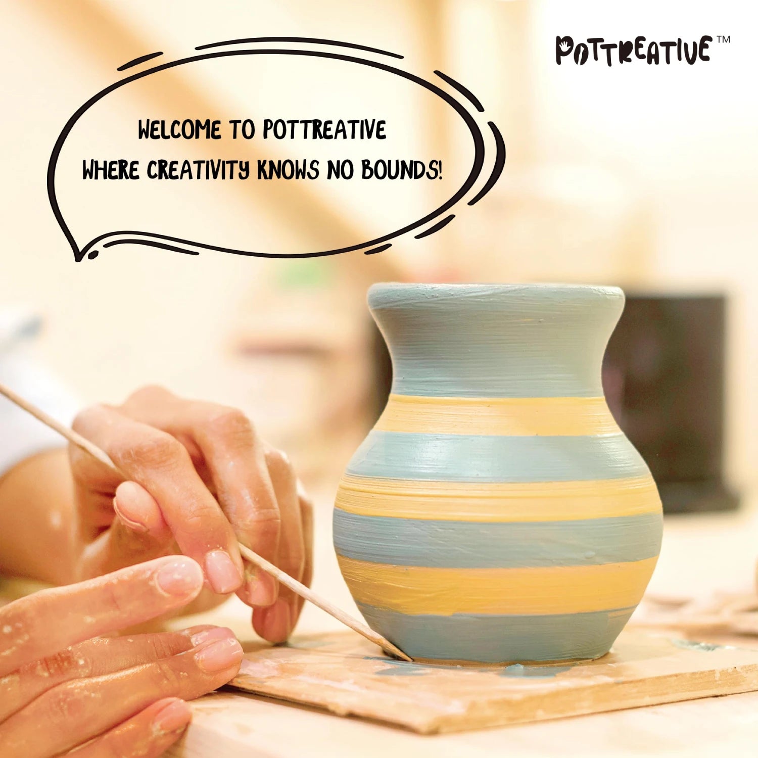 Person painting a striped clay vase.