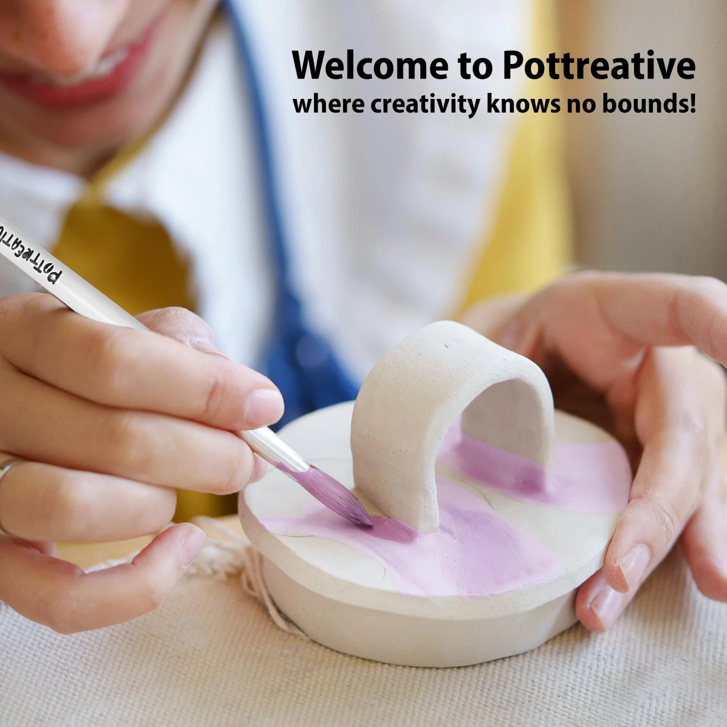 A person enjoying a creative session, painting a handmade item with the Pottreative air dry clay pottery kit for adults and kids.