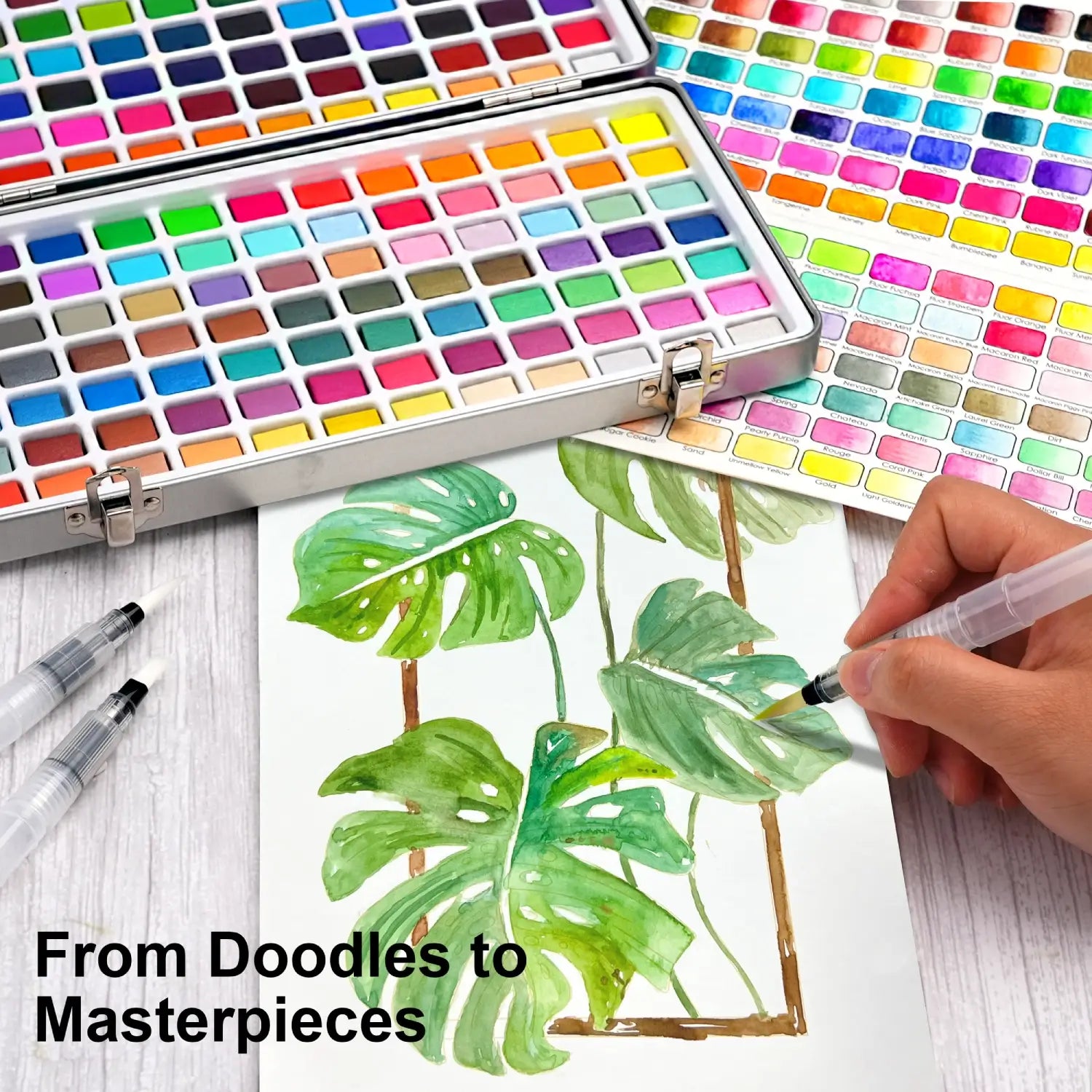 An artist painting vibrant green monstera leaves, showcasing the creative potential of the 168 colors watercolor paint set, from doodles to masterpieces.